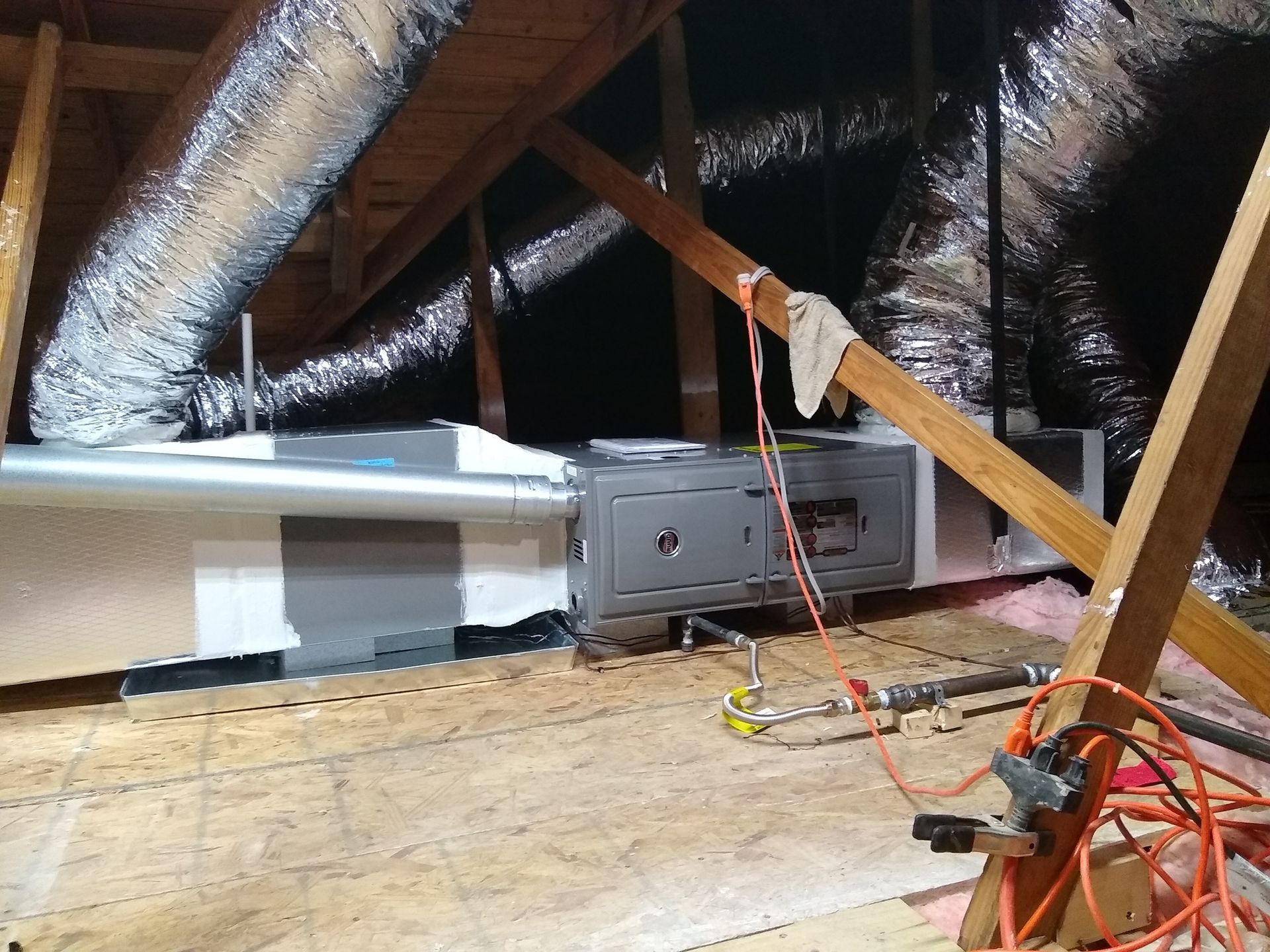 An attic with a bunch of ducts coming out of it