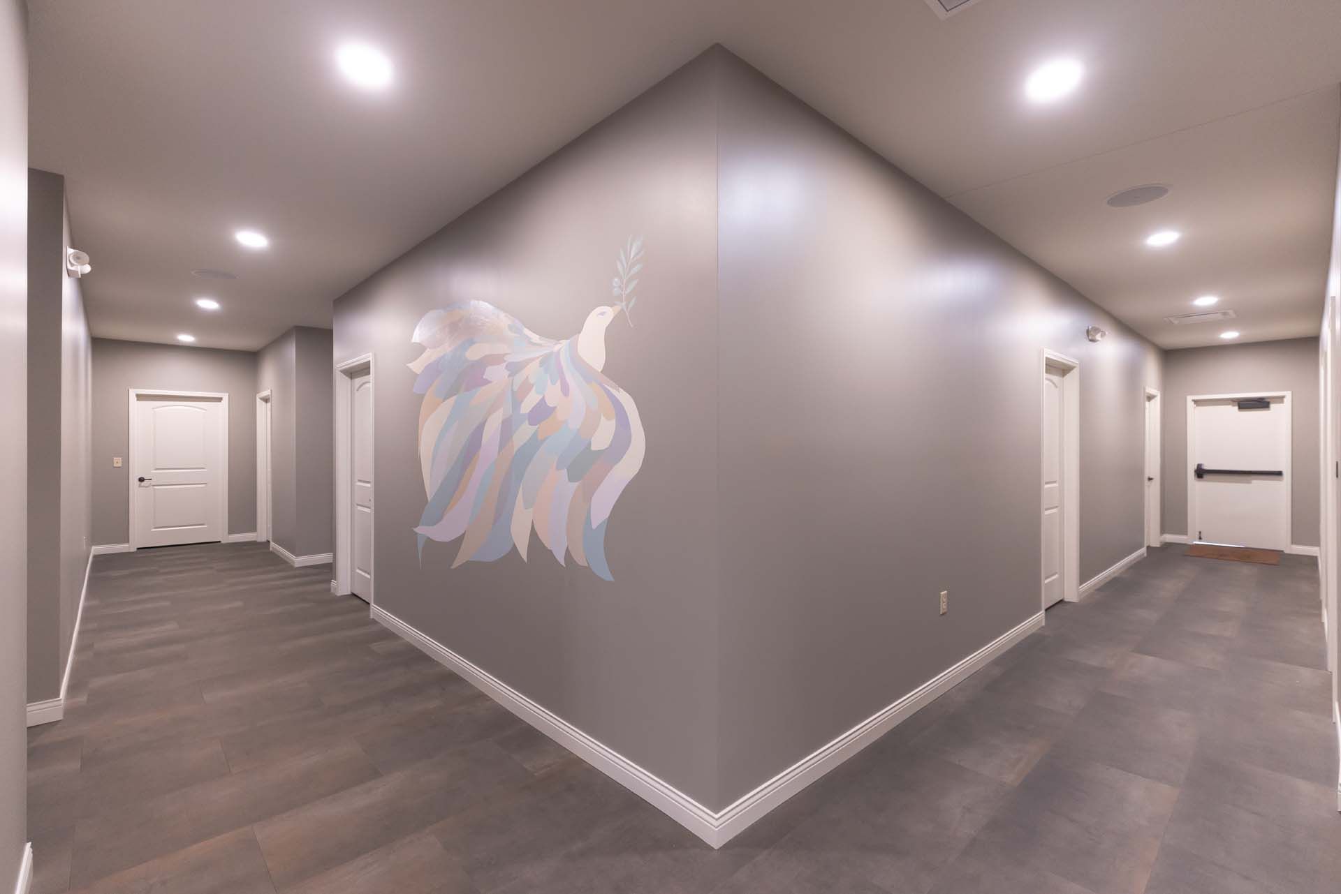 a hallway with a painting on the wall