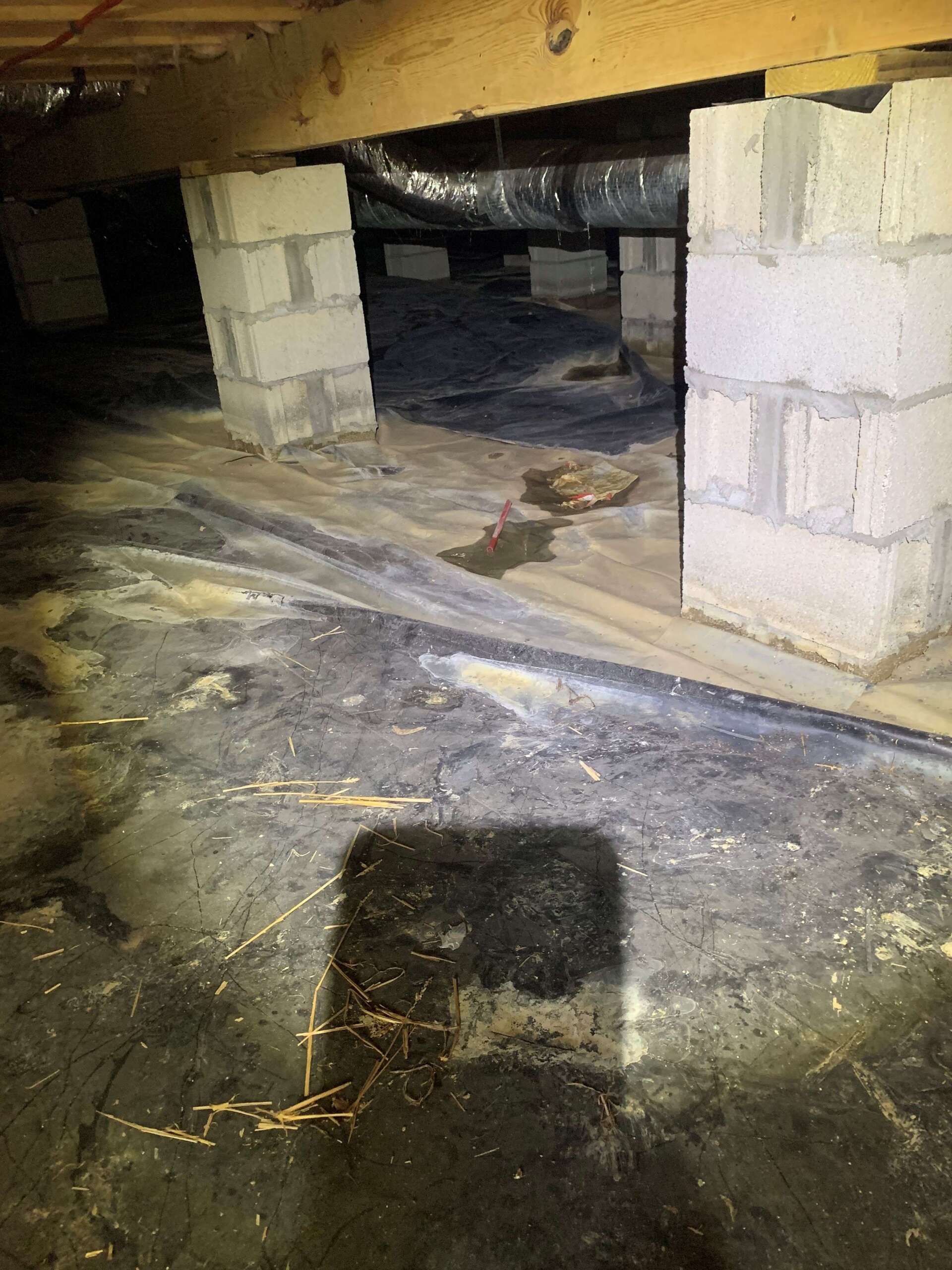 A shadow of a person is cast on the floor of a basement.