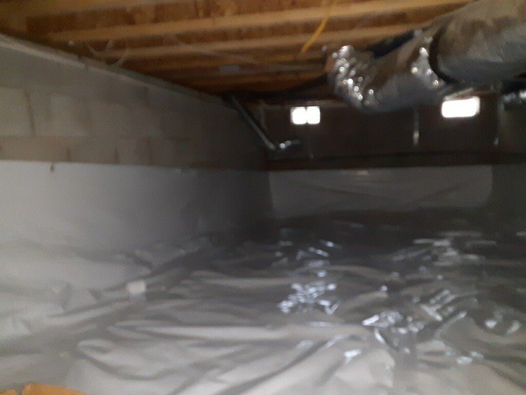 A basement with a lot of plastic on the floor
