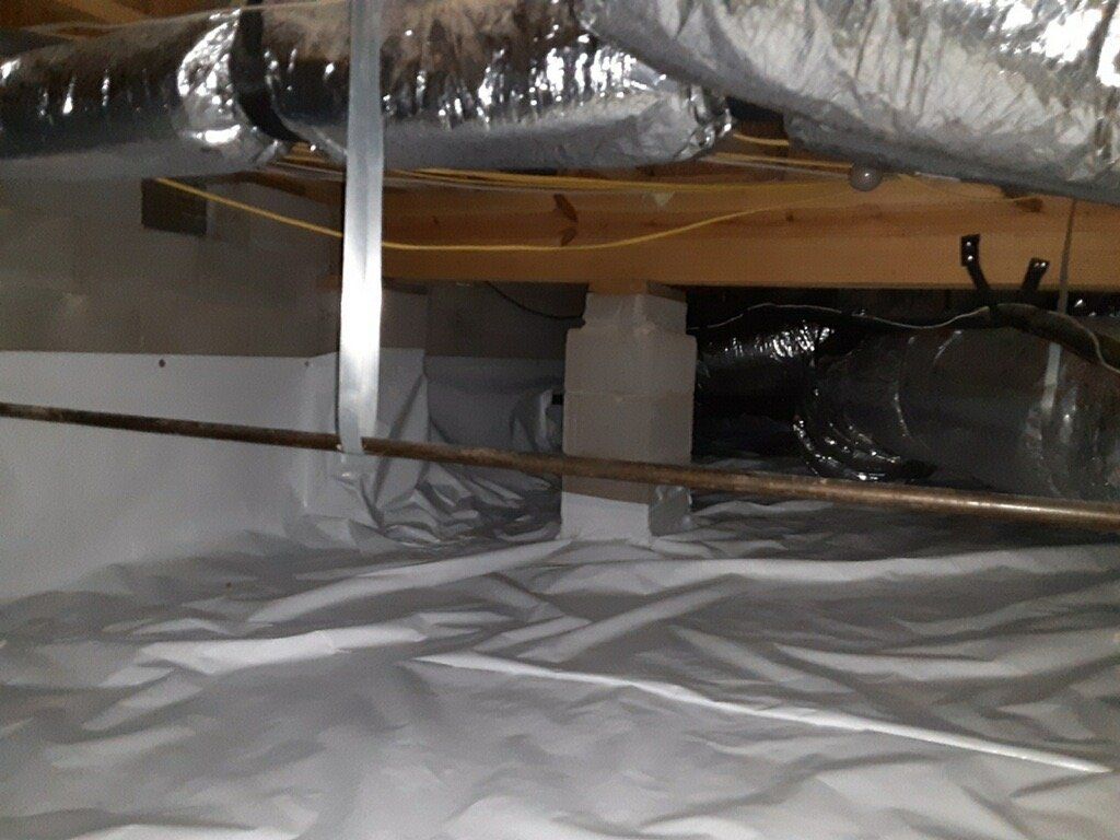 A basement with a lot of pipes coming out of it.