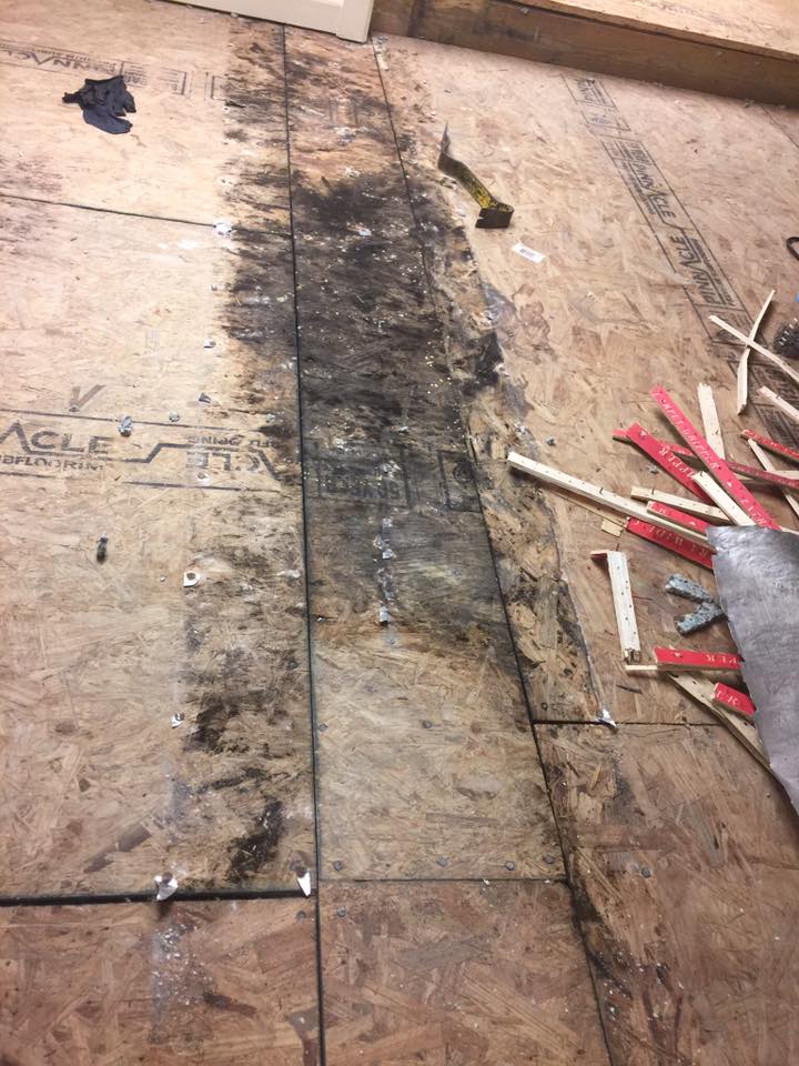A wooden floor with a lot of pieces of wood on it.