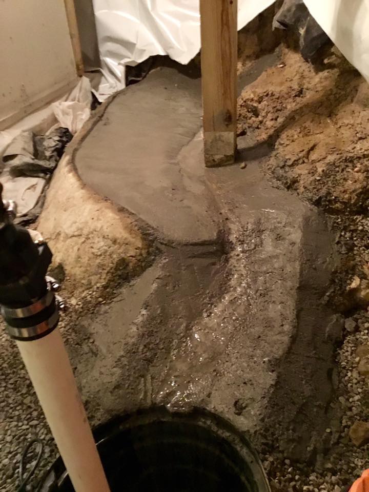 A pump is being installed in a basement.
