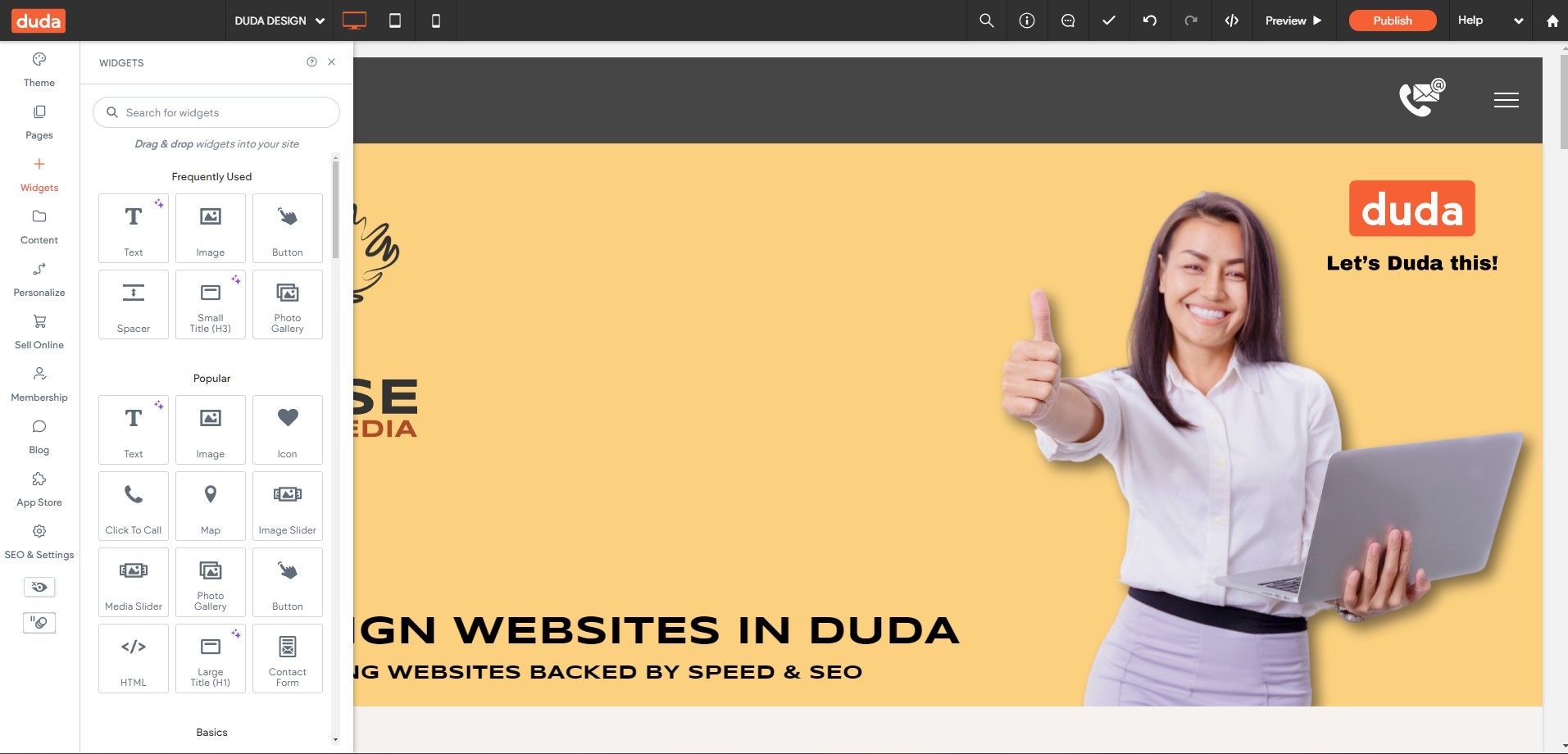 A woman is holding a laptop and giving a thumbs up.