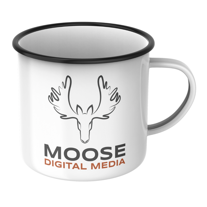 A white mug with moose digital media written on it