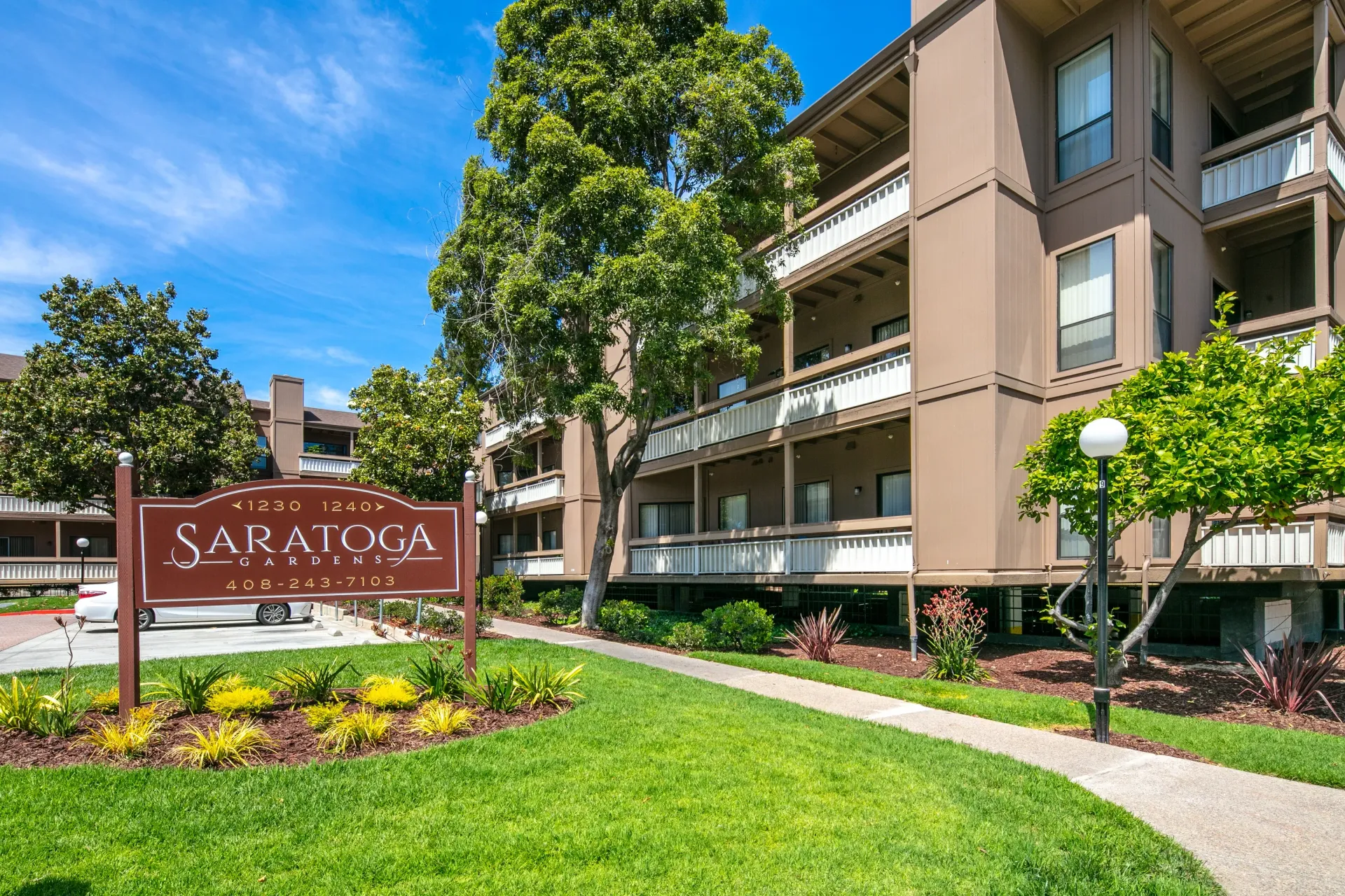 Saratoga Gardens apartment building exterior with monument sign.