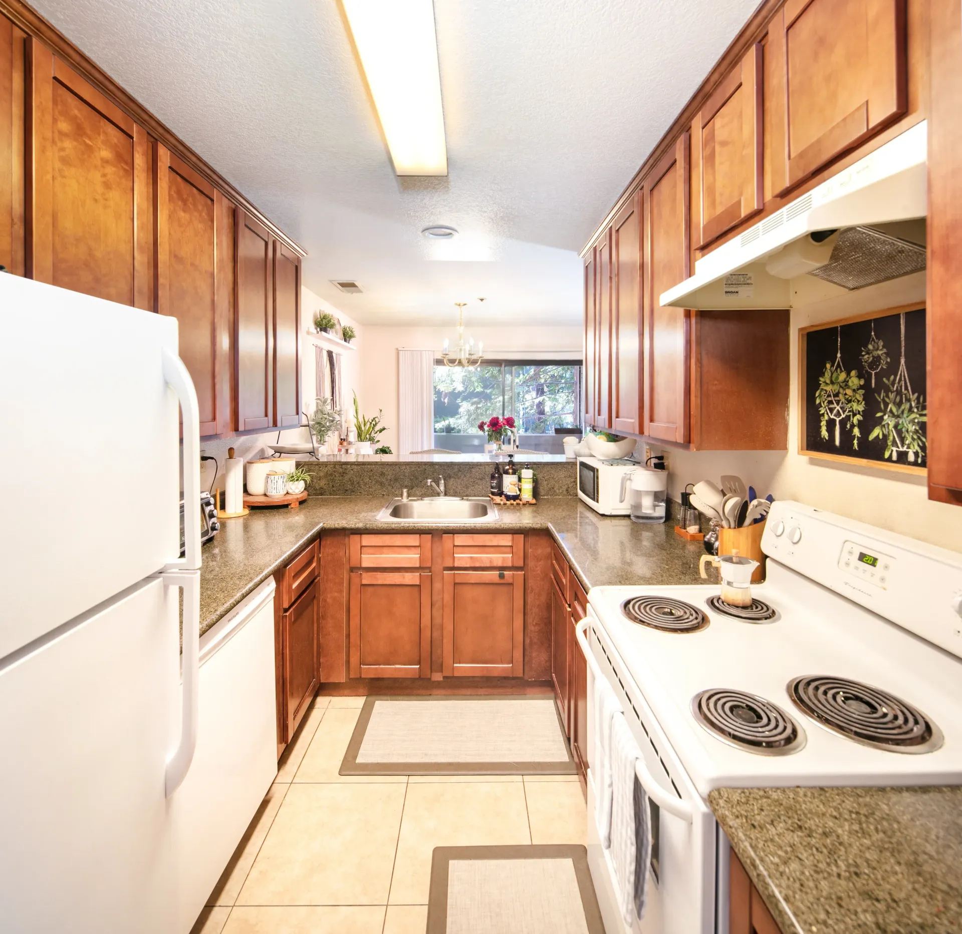 Kitchen with wooden cabinets and granite countertops.