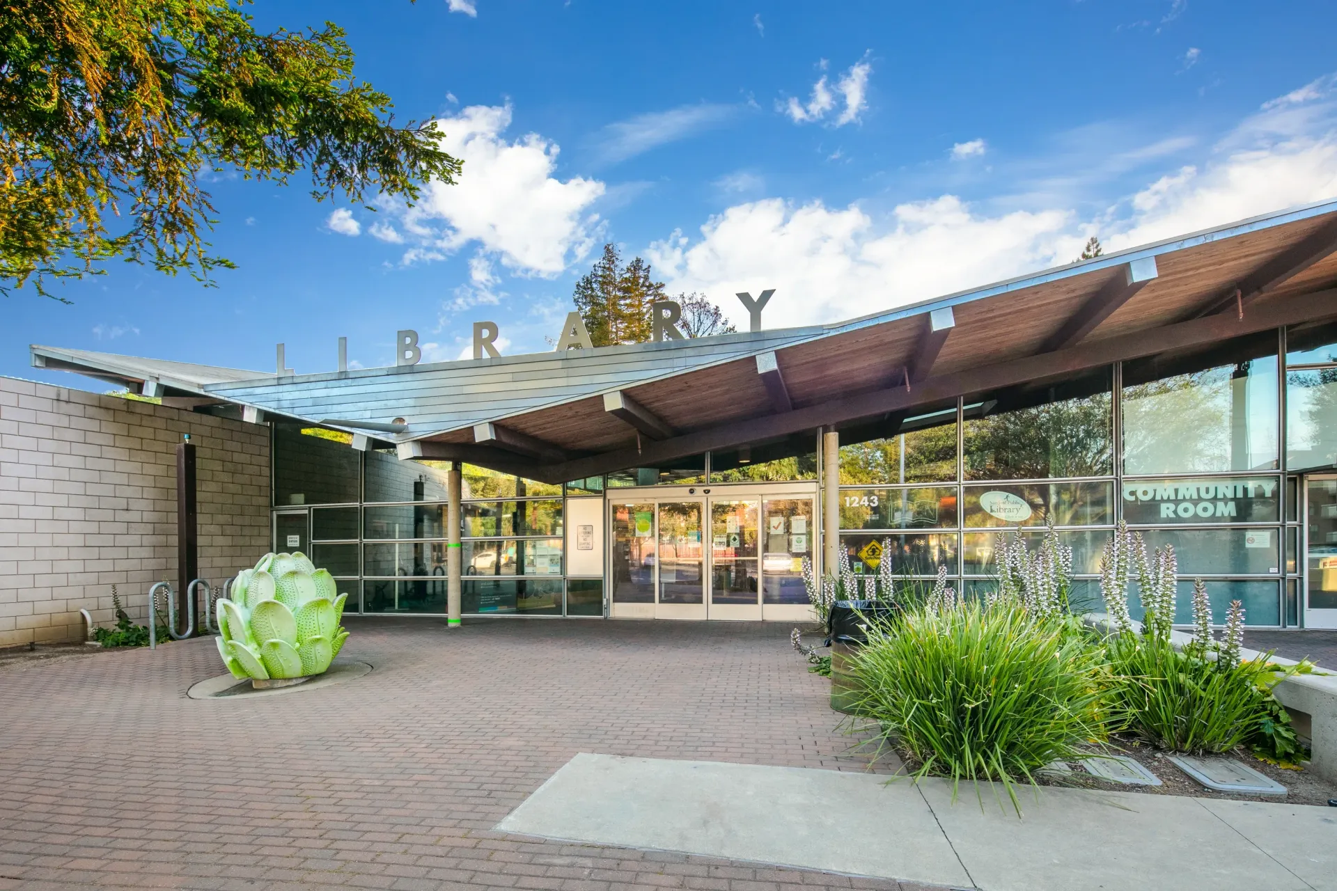 Library entrance with modern architecture and landscaping.