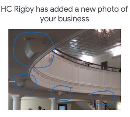 Curved white balcony inside a building, with blue circles highlighting damaged ceiling and wall areas.