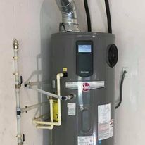 Fast Track Plumbing technician installing a water heater with pipes and vents for Plumbing Installation Spring TX.