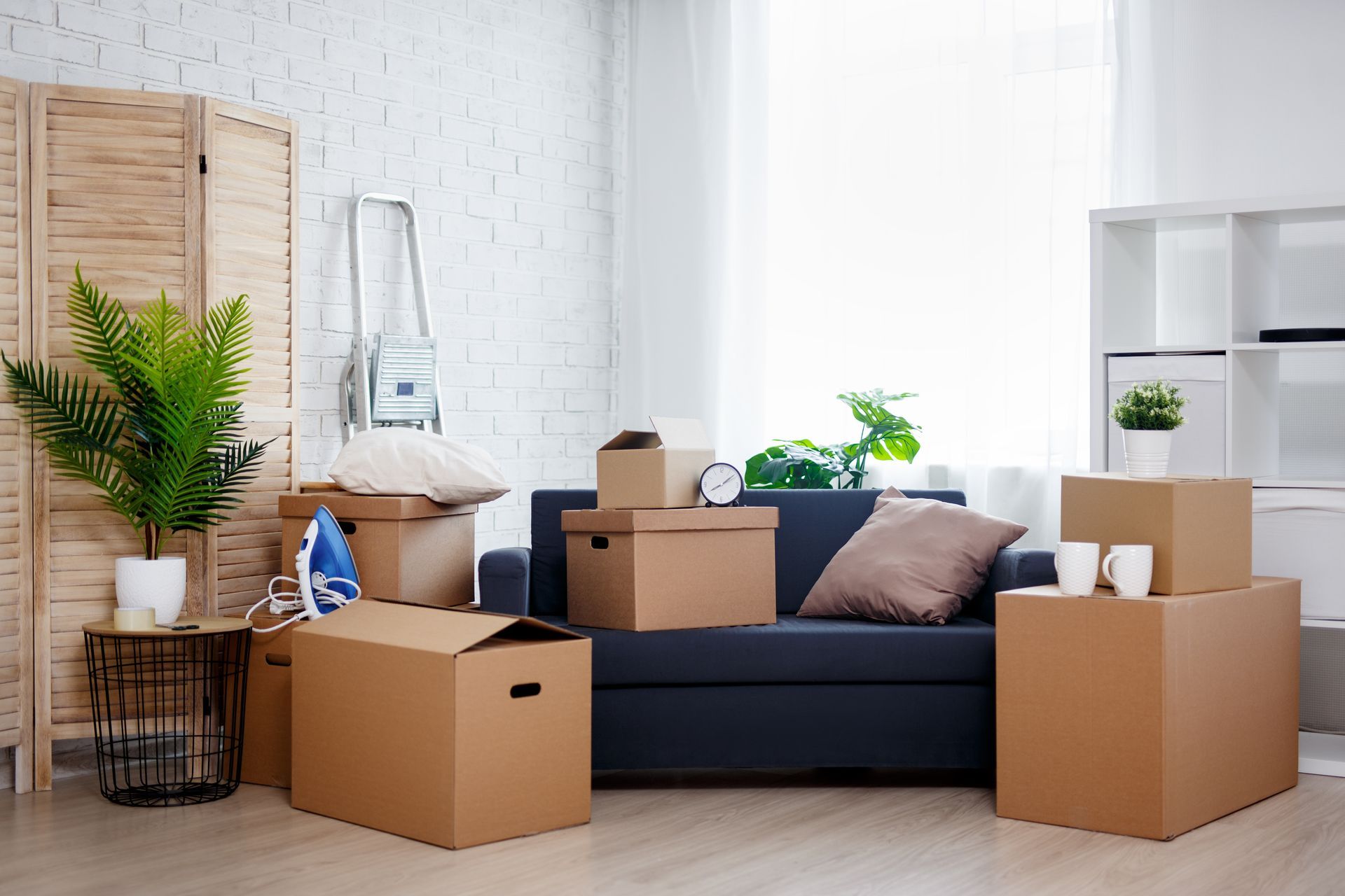 Living room with a couch and moving boxes