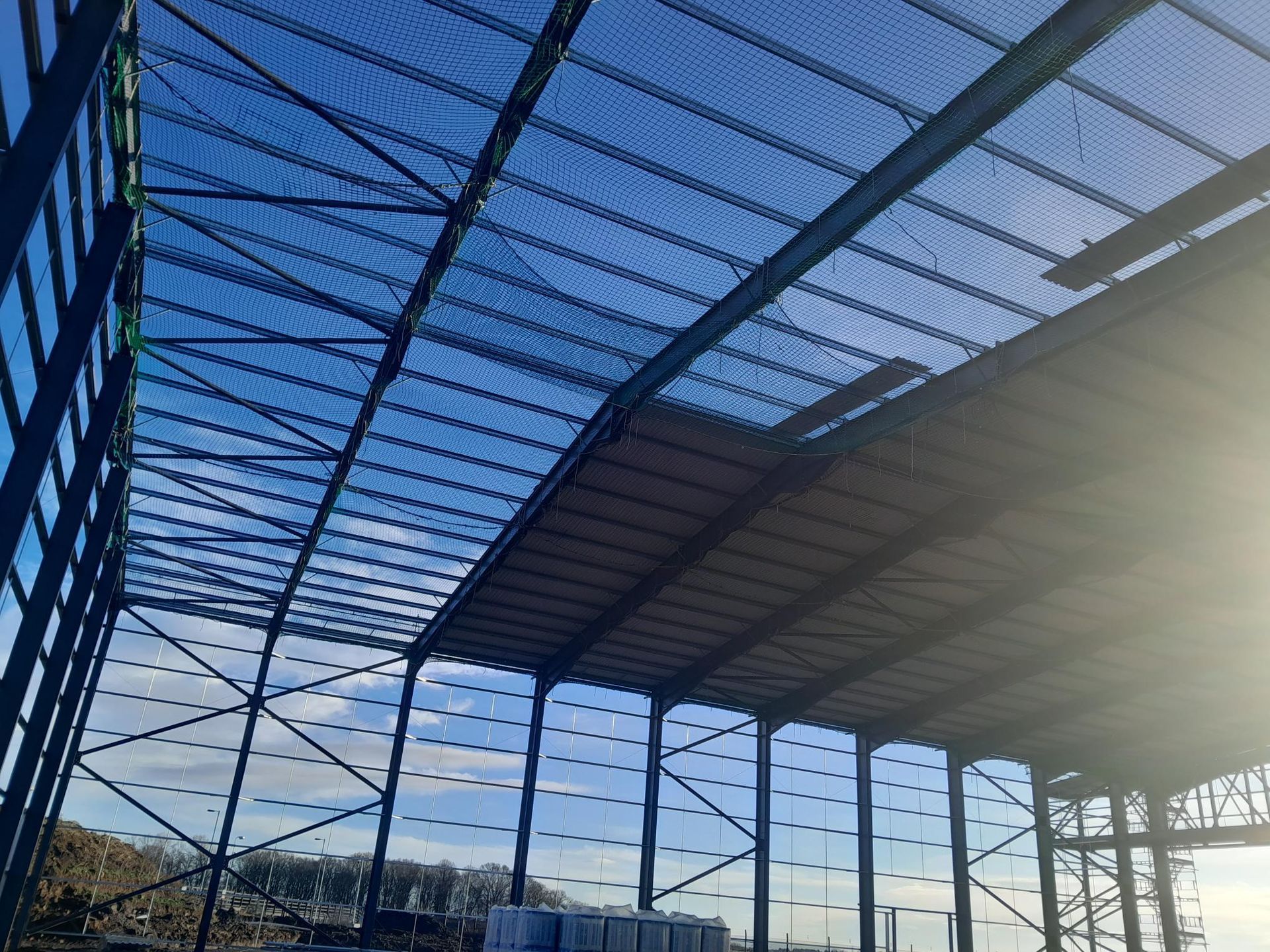 A large building under construction with a blue sky in the background.