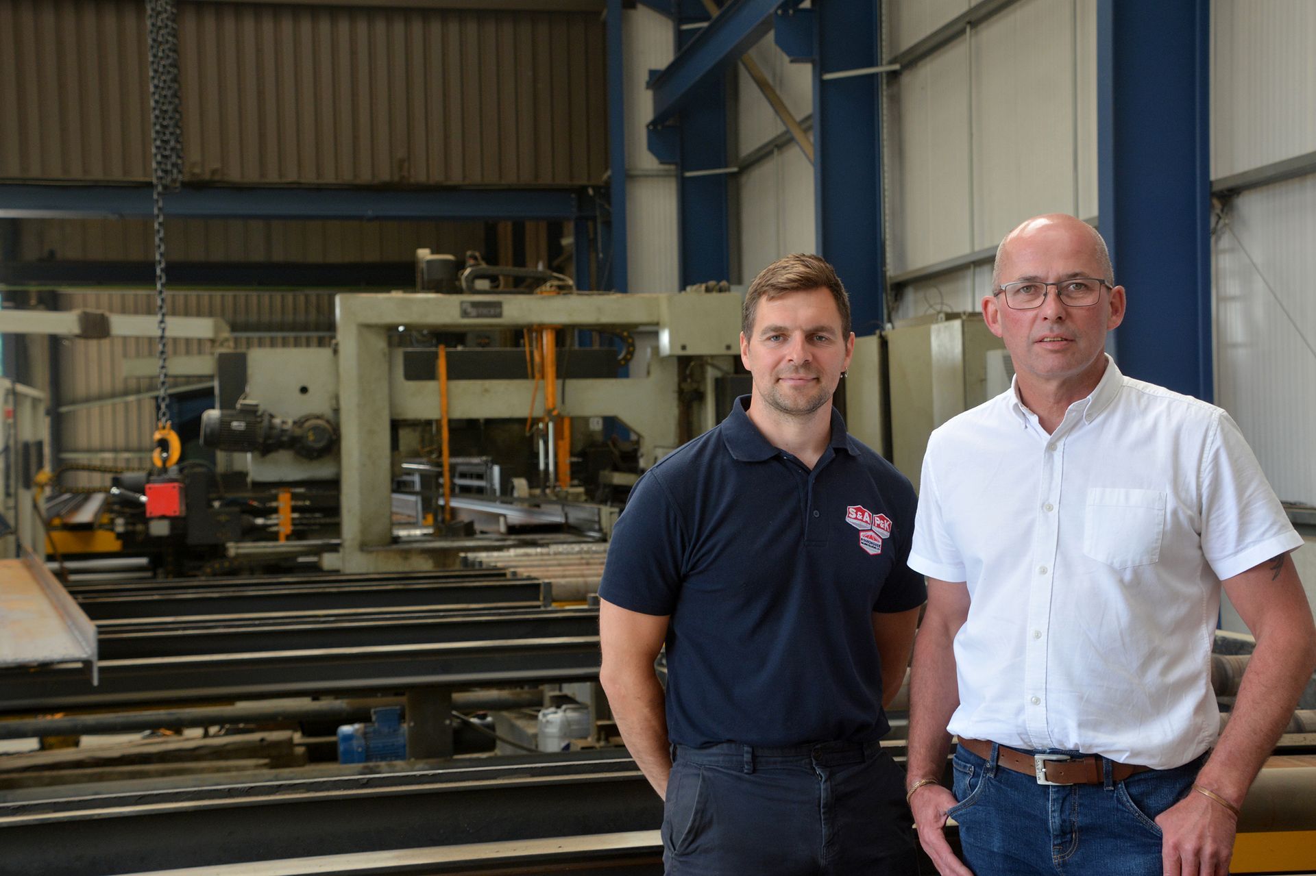 Rob & David are standing next to each other in the factory.