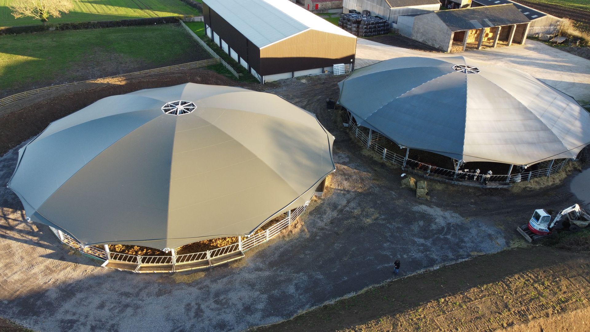 An aerial view of a farm with a lot of round buildings