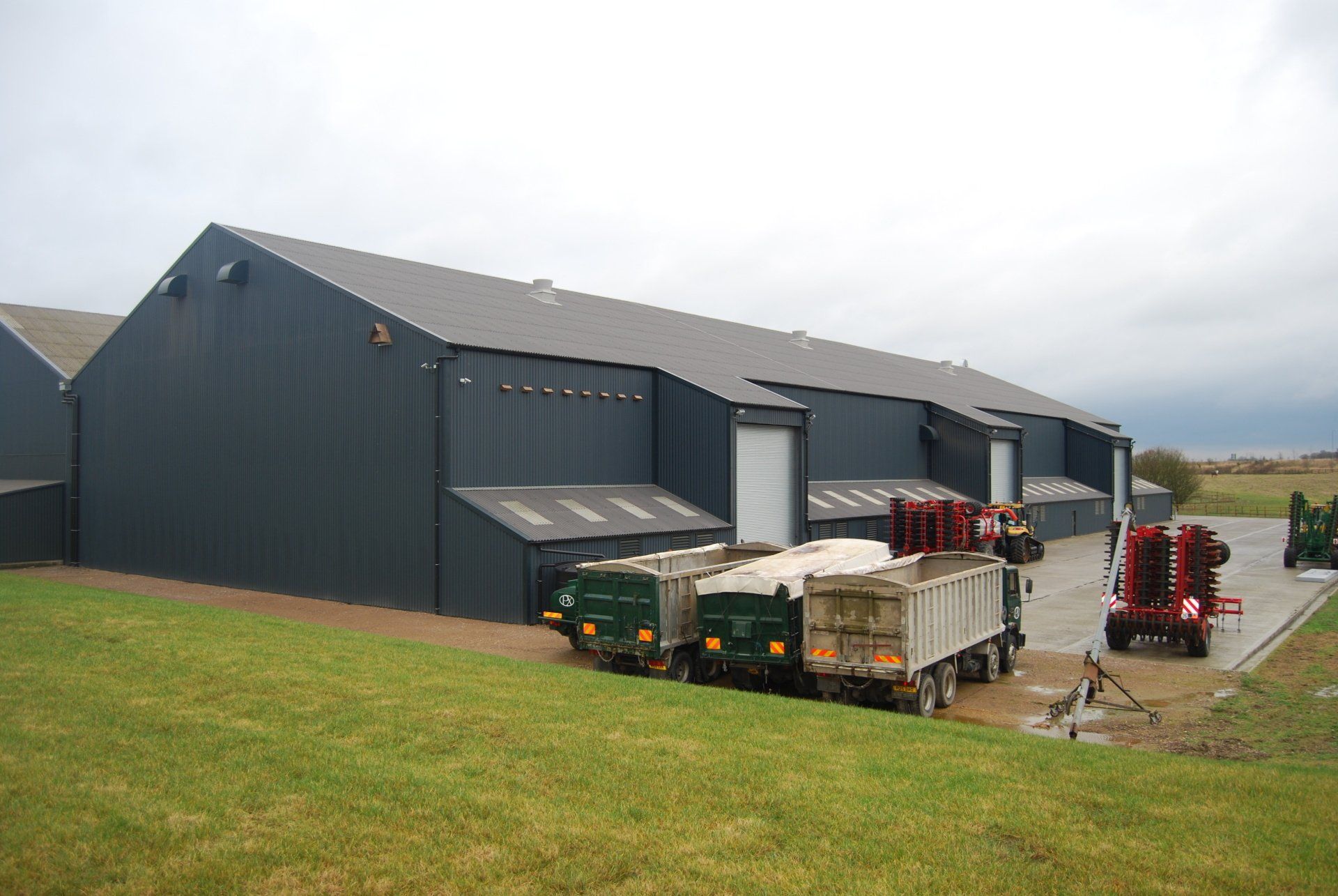 A large building with a lot of trailers parked in front of it.