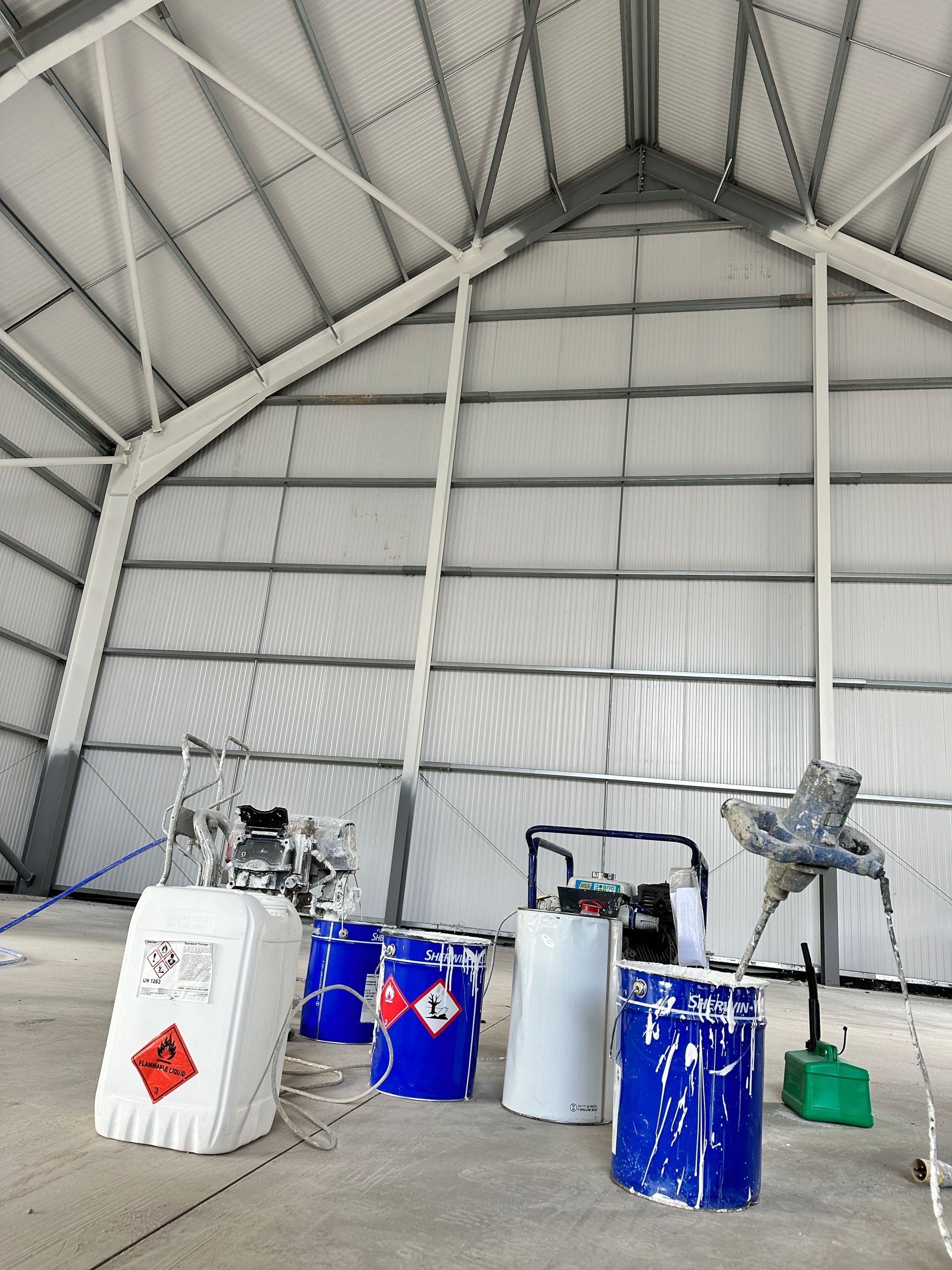 A row of blue and white barrels in a building