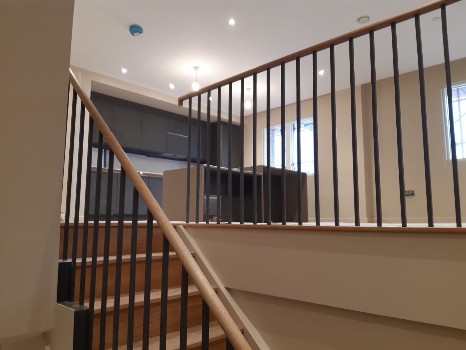 A wooden staircase with a metal railing in a house