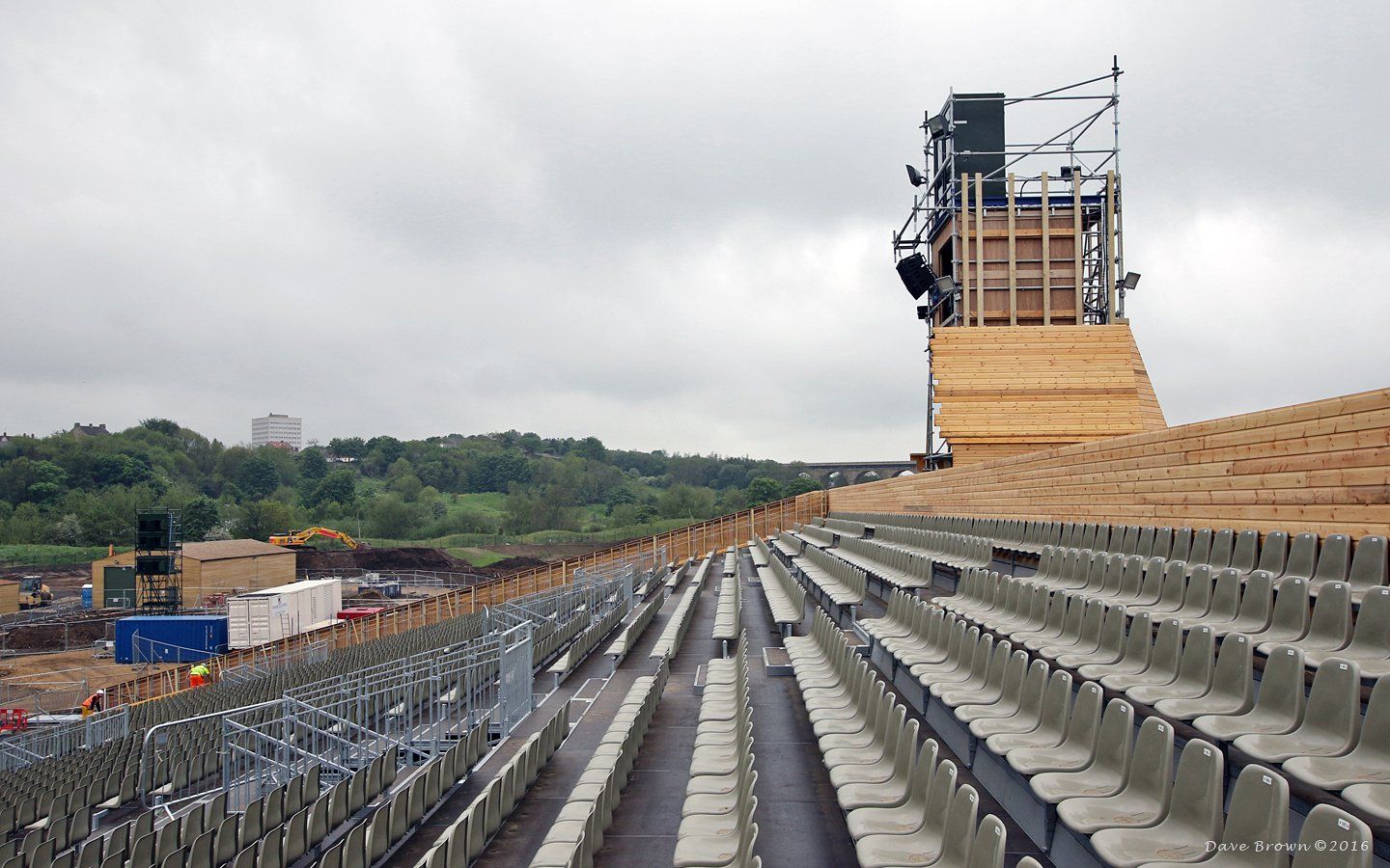 An empty stadium with a wooden structure in the background
