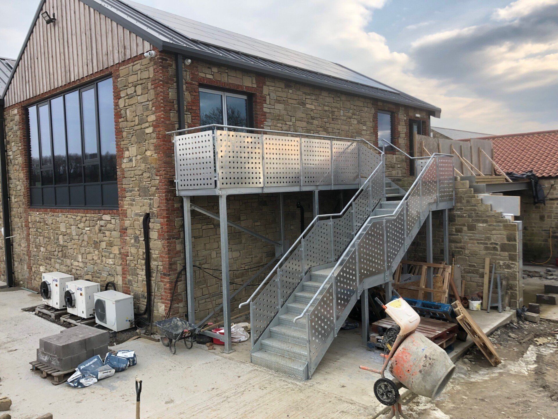 A building under construction with stairs leading up to the second floor.