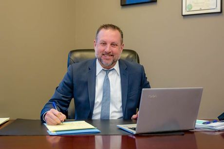Brian E. King at desk