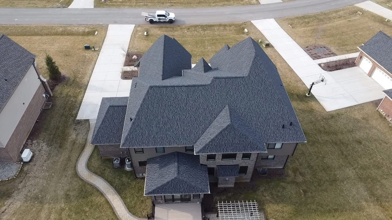 An aerial view of a large house in a residential area.