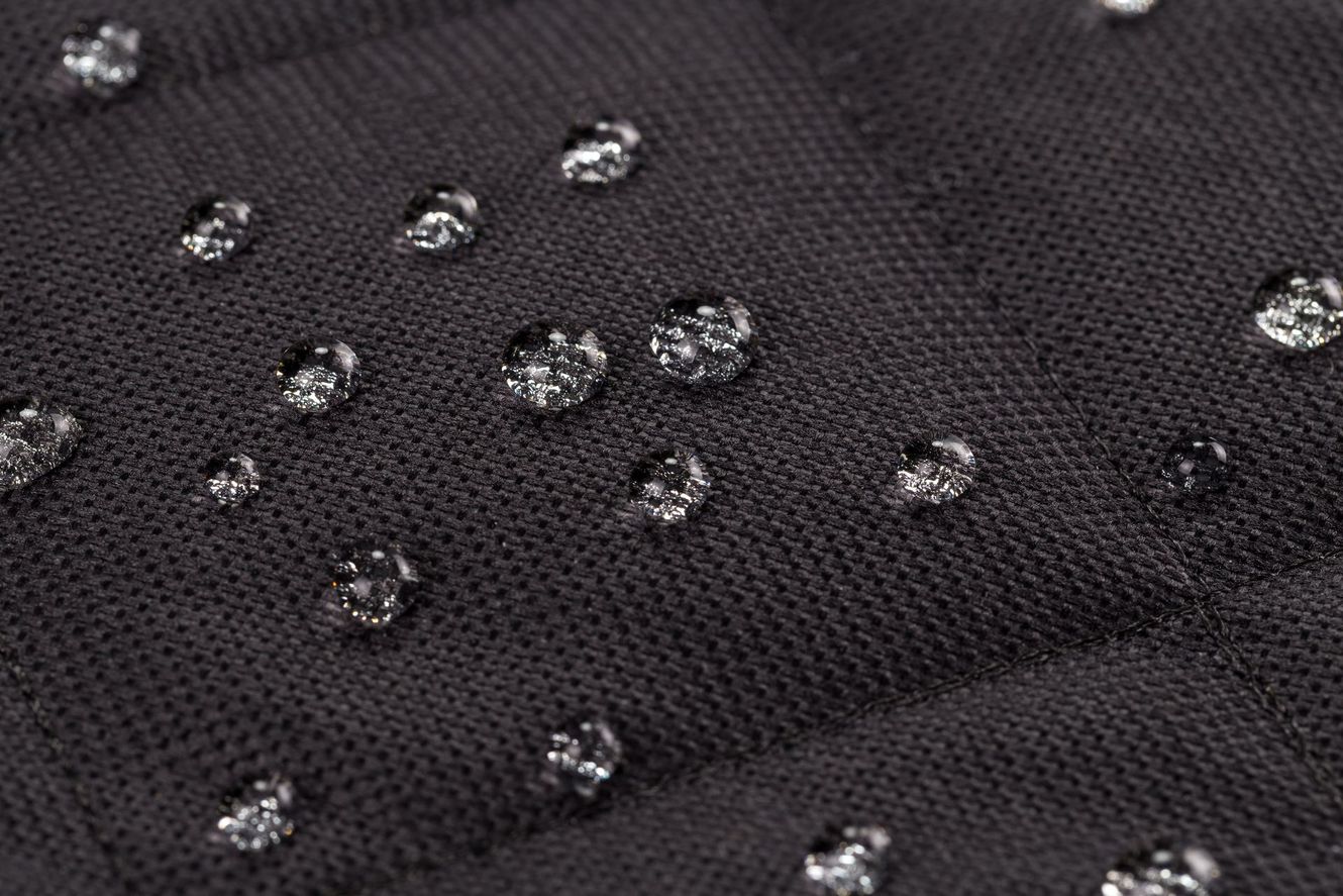 Black fabric with water droplets.