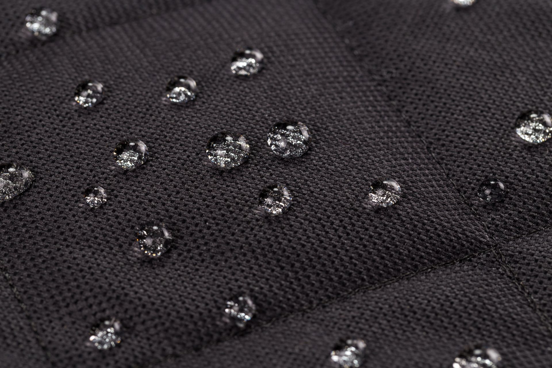 Black fabric with water droplets.