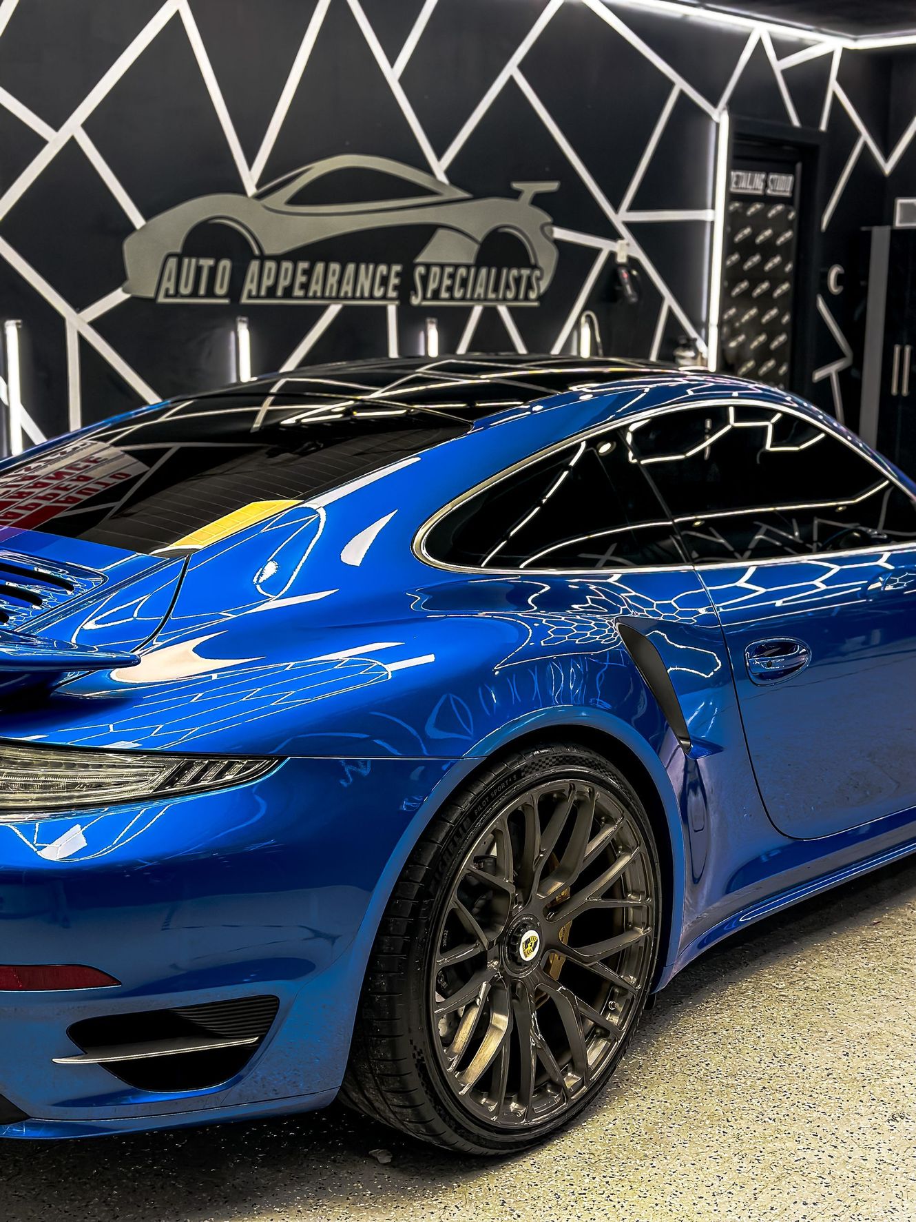 Blue Porsche sports car being detailed at Auto Appearance Specialists.