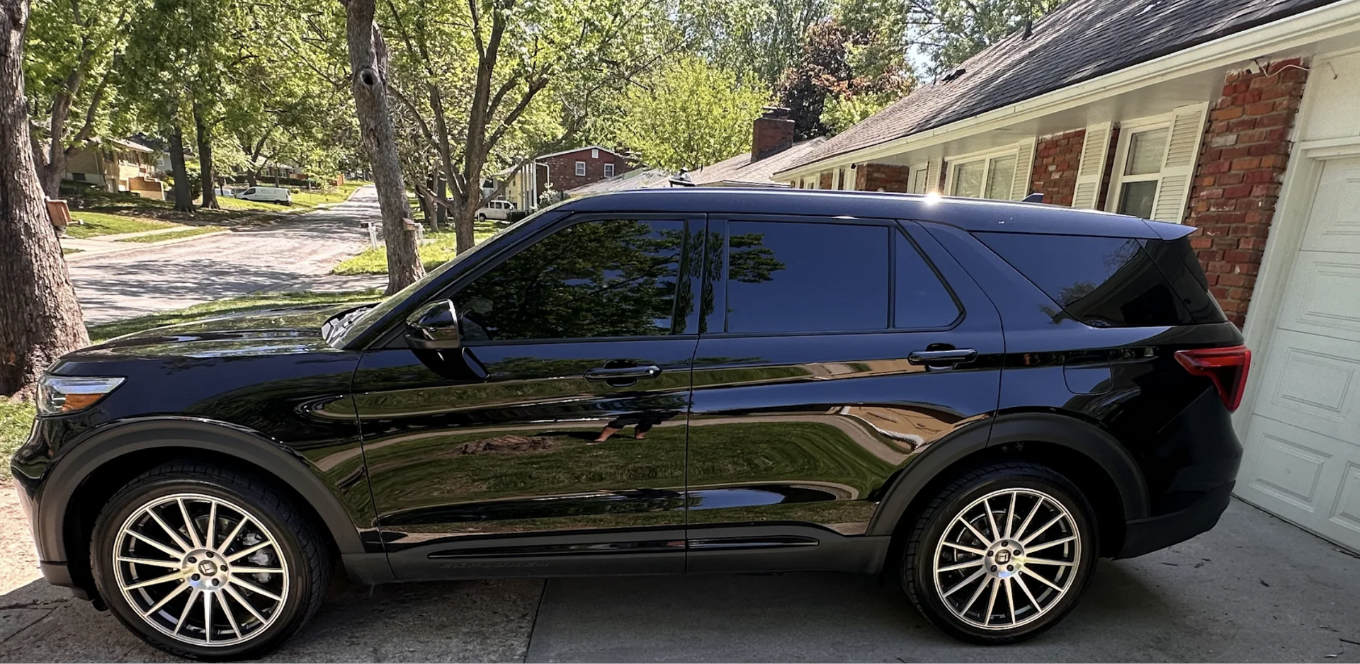 Black Ford Explorer parked in front of a house.