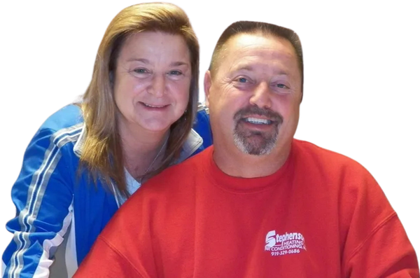 Two smiling people, one in a blue top and one in a red shirt, posed against a white background