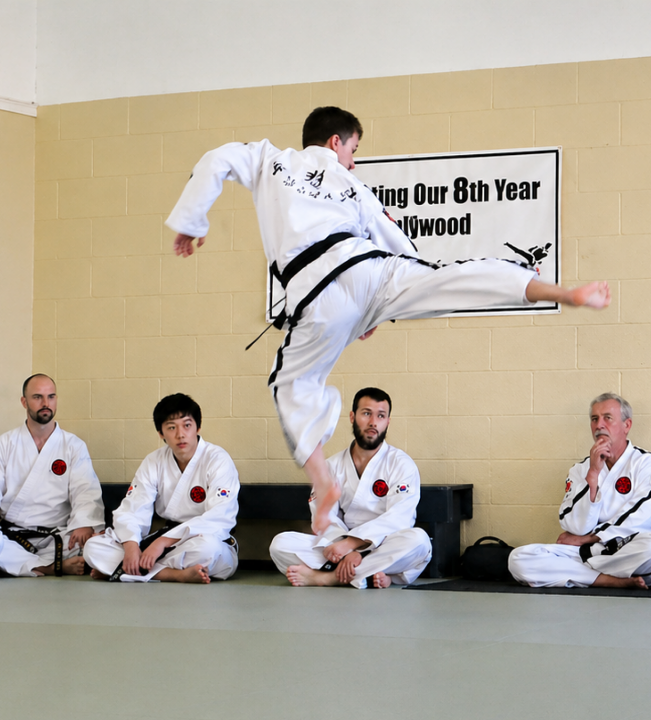 an instructor demonstrating a jumping kick
