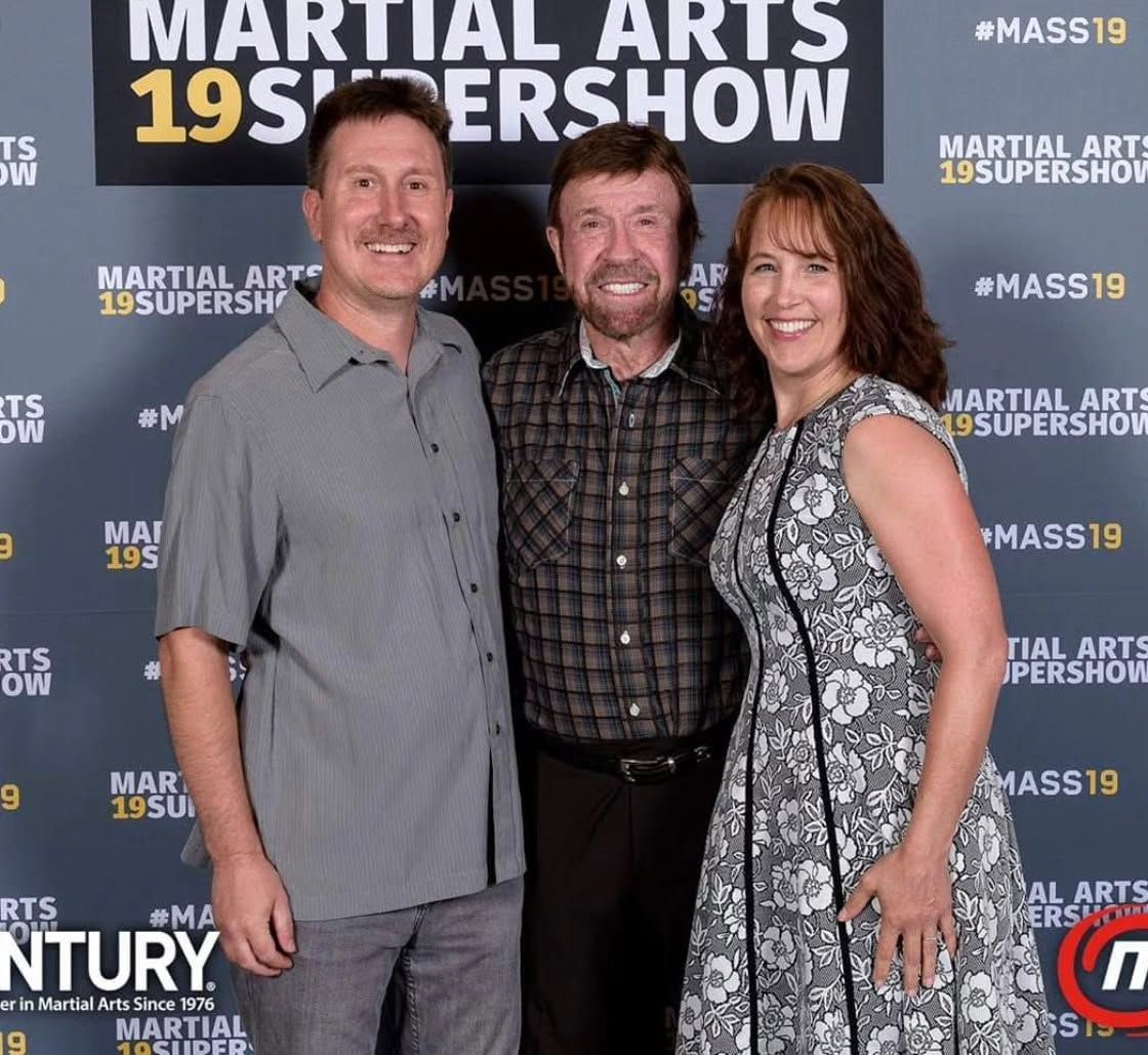 Two instructors posing with a martial art actor