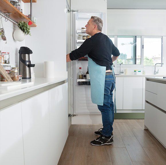 Man Looking Inside Fridge — San Pablo, CA — Alvarez Appliance Repair Man Looking Inside Fridge — San Pablo, CA — Alvarez Appliance Repair