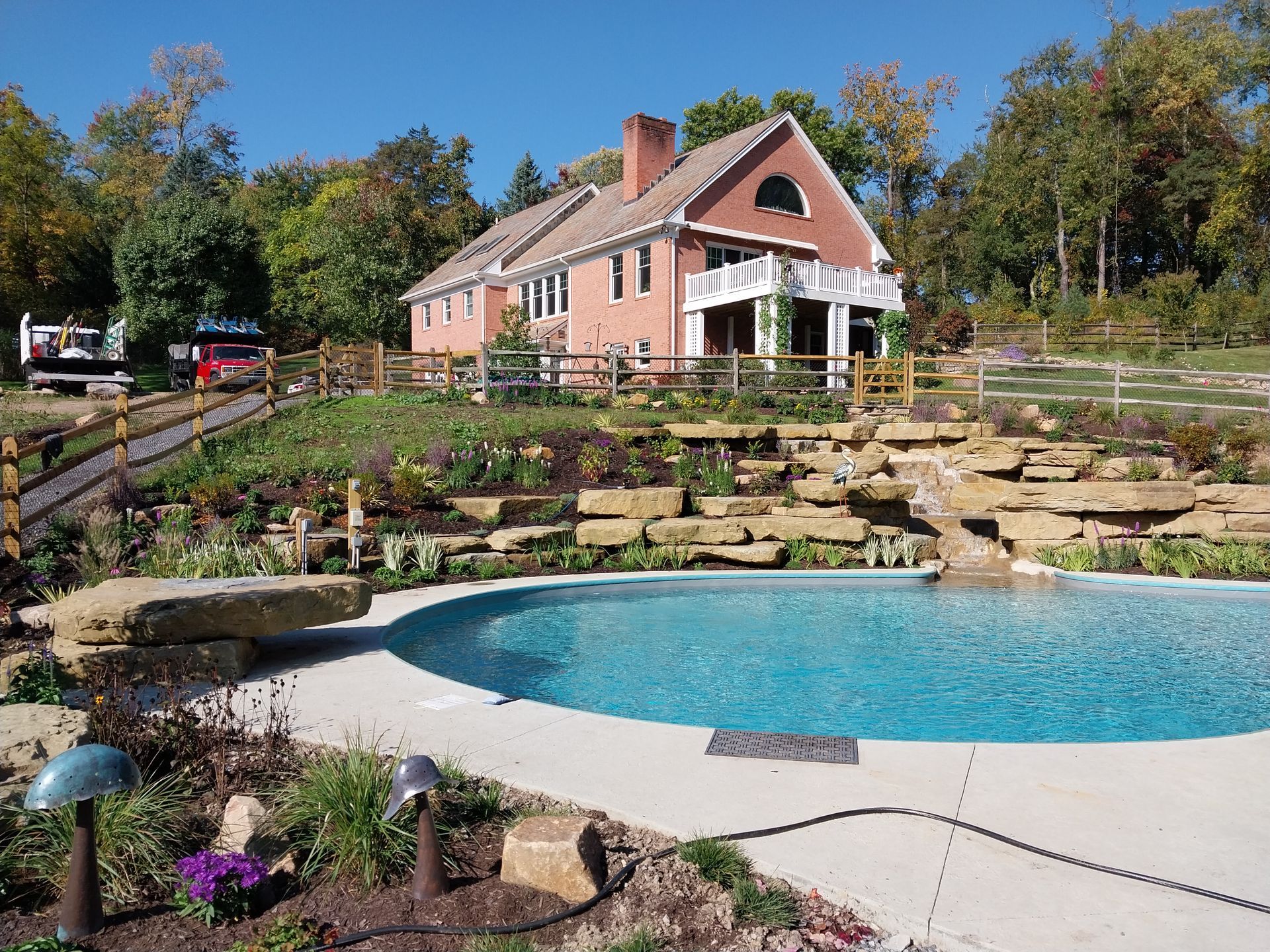 A large house with a swimming pool in front of it