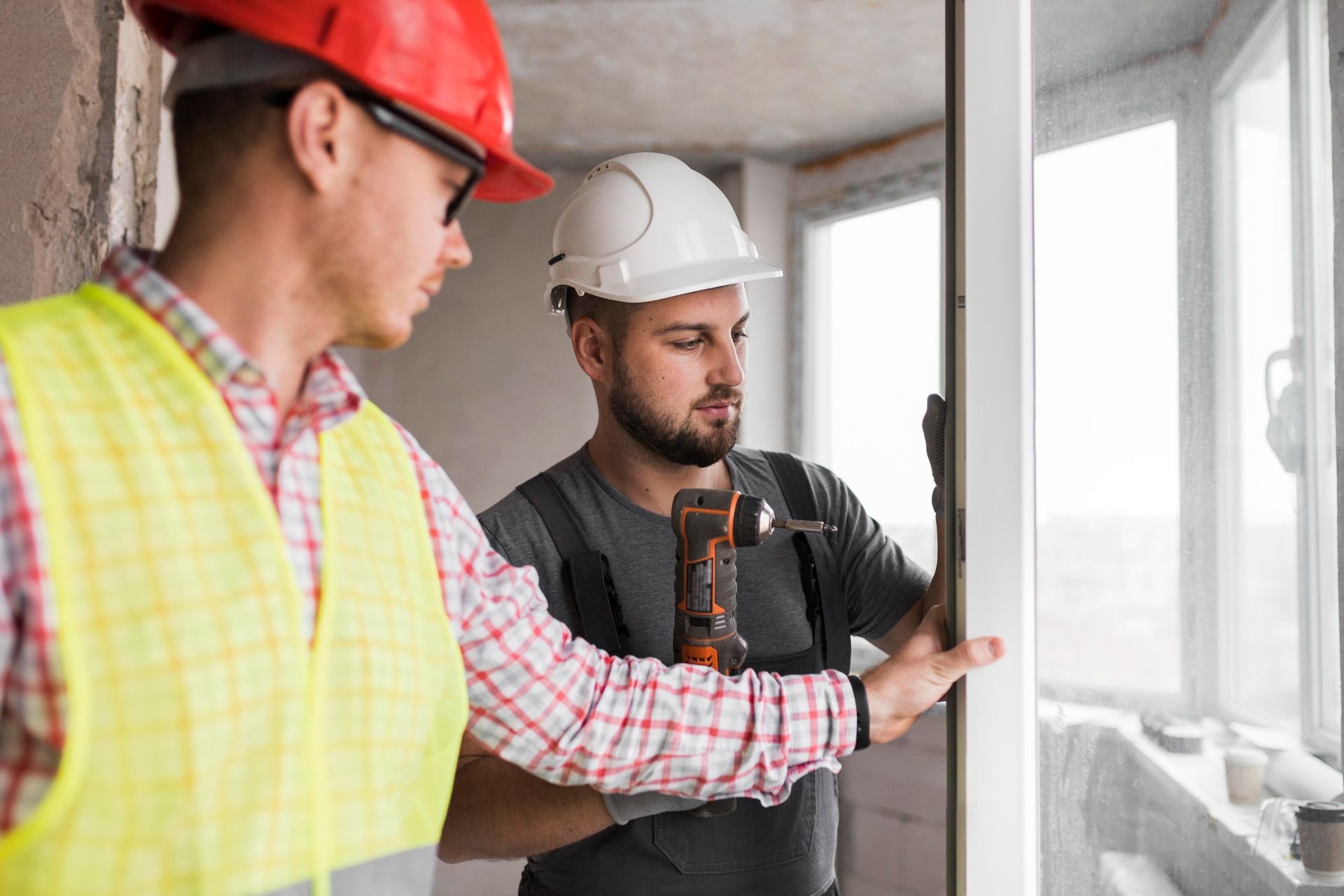 Construction workers install windows
