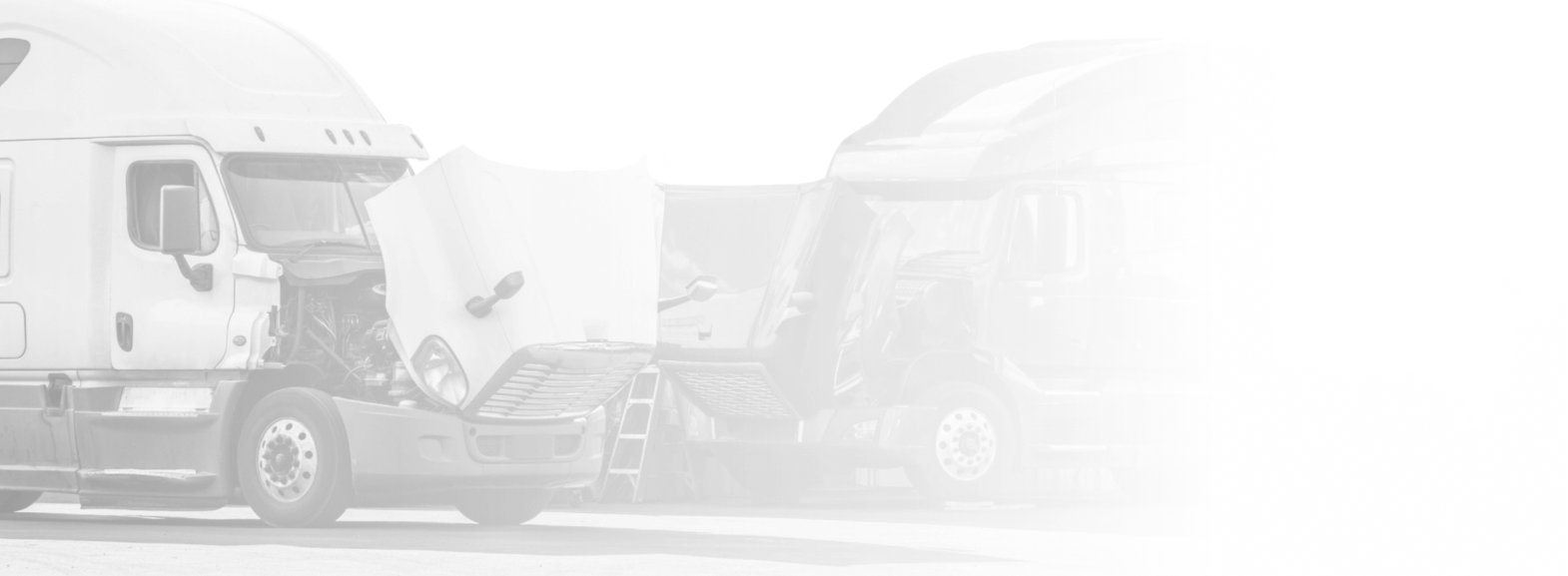 Two semi-trucks, one with its hood up, faded in a bright setting.