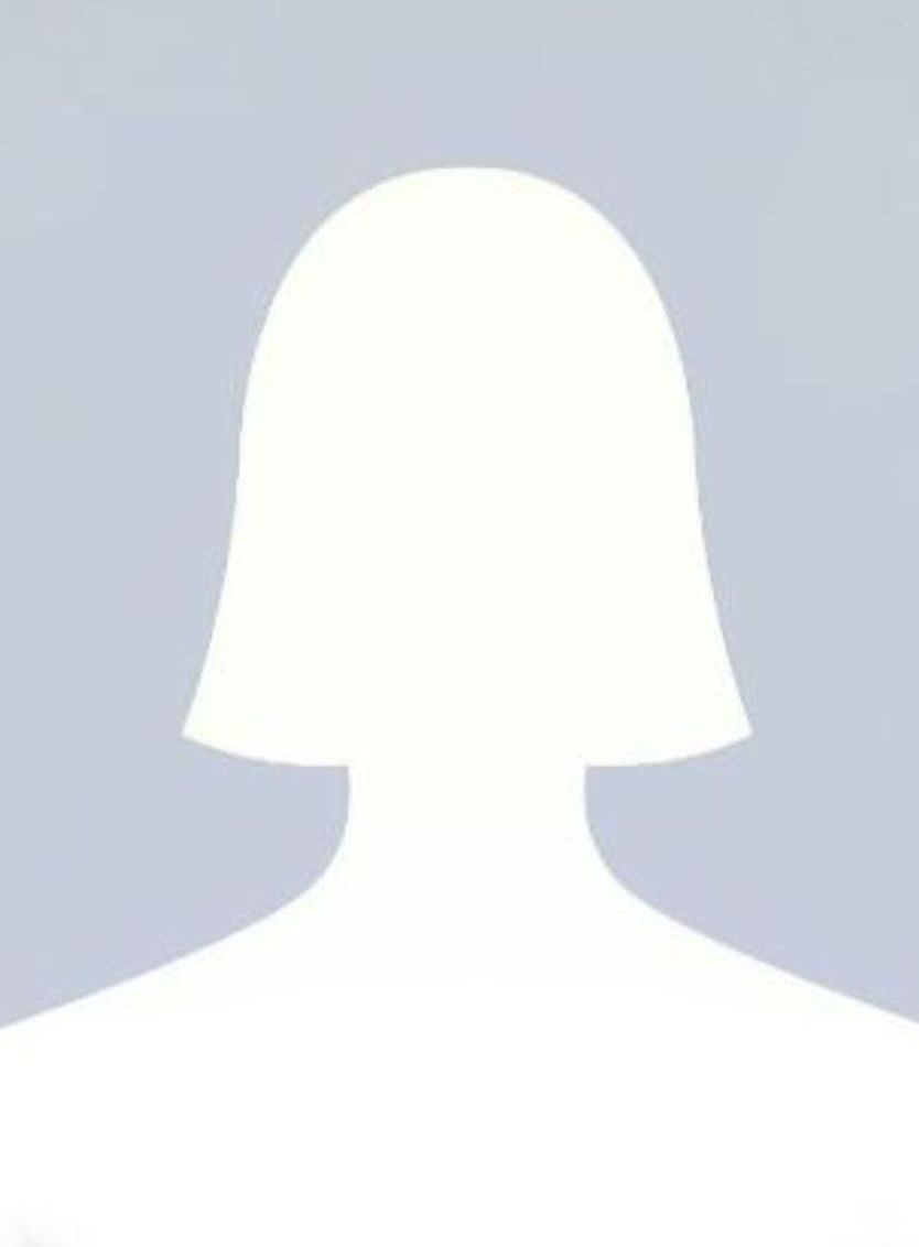 Silhouette of a person with short hair, shoulders, and a blurred background.