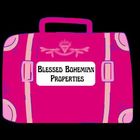 Pink suitcase labeled “Blessed Bohemian Properties” on a black background