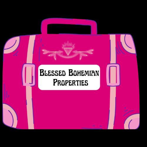 Pink suitcase labeled “Blessed Bohemian Properties” on a black background