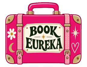 Pink suitcase labeled “Blessed Bohemian Properties” on a black background