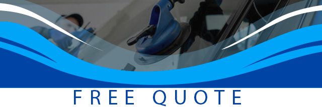 Blue banner displaying ‘Free Quote’ offer in front of a two people replacing a windshield.