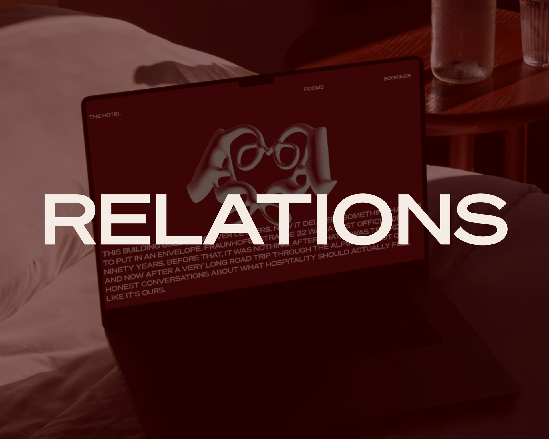 Laptop on a bed with large white text “RELATIONS” over a red-tinted screen.