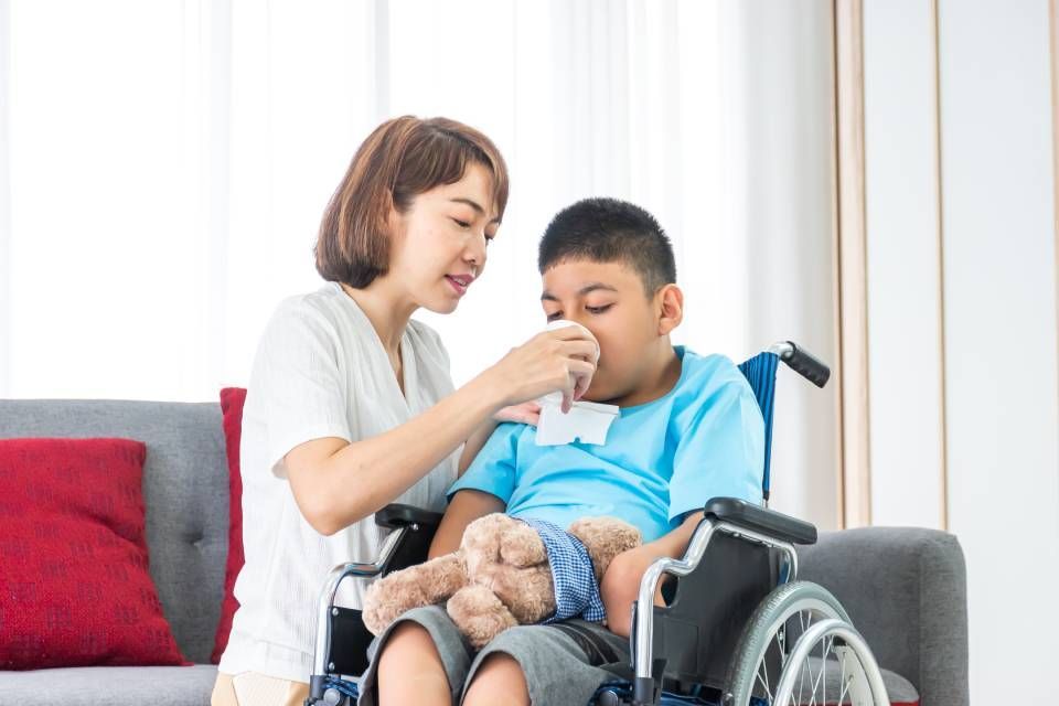 a woman helping a disabled child