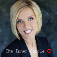 A woman is smiling in front of the inner circle logo. Happy client after planning meeting for her. 