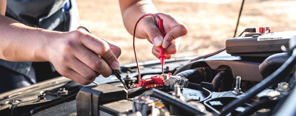 Hands Using Tools to Work on an Open Car Engine in a Garage — Wingham Mechanical in Wingham, NSW