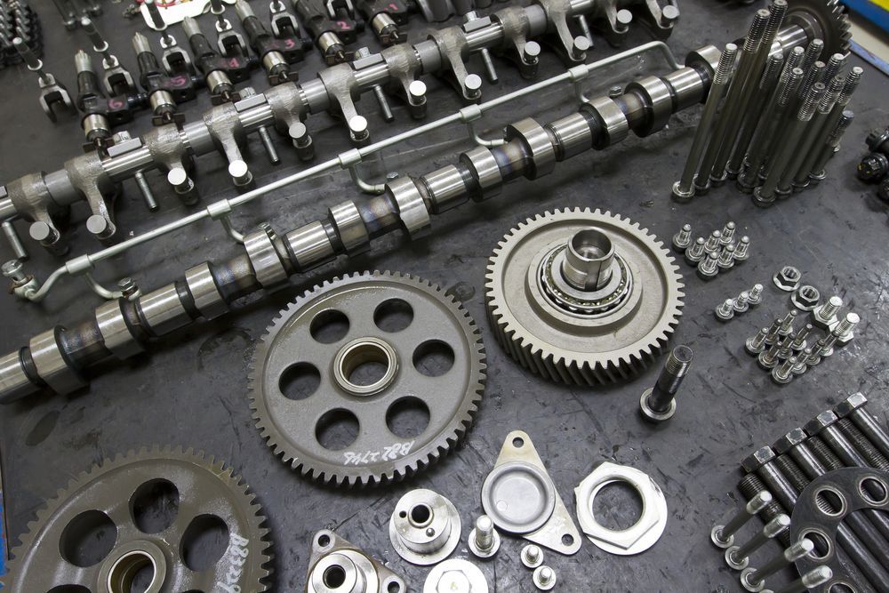Assorted Metal Gears and Camshafts Arranged on A Dark Surface — Wingham Mechanical in Wingham, NSW