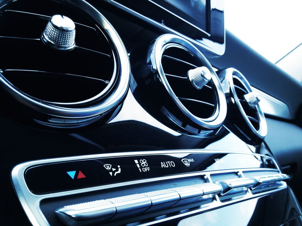 Close-up Of a Car Dashboard With Chrome Air Vents and Climate Controls — Wingham Mechanical in Wingham, NSW