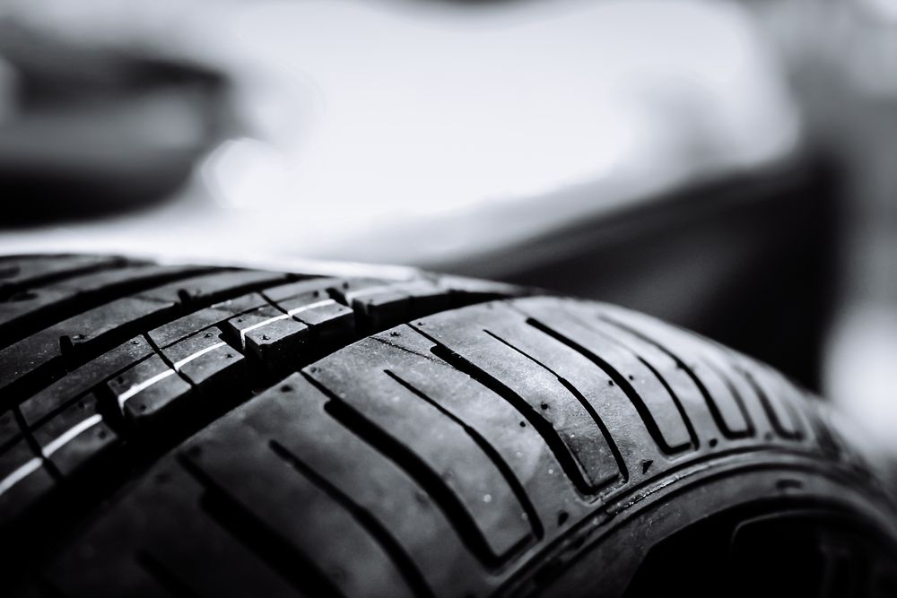 Close-Up of A Black Car Tire Tread on A Vehicle, with A Blurred Background — Wingham Mechanical in Wingham, NSW