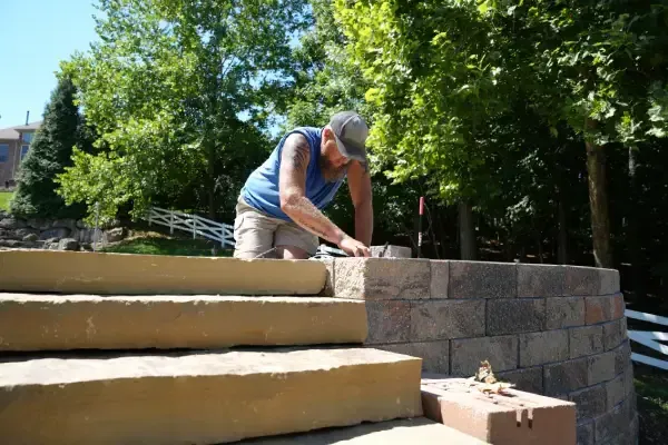 Retaining wall defining and supporting a landscaped area