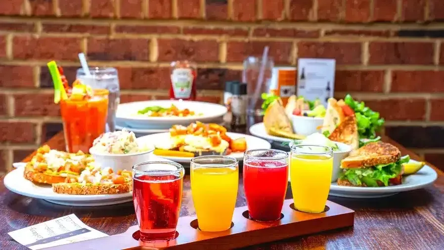 A table topped with plates of food and drinks.